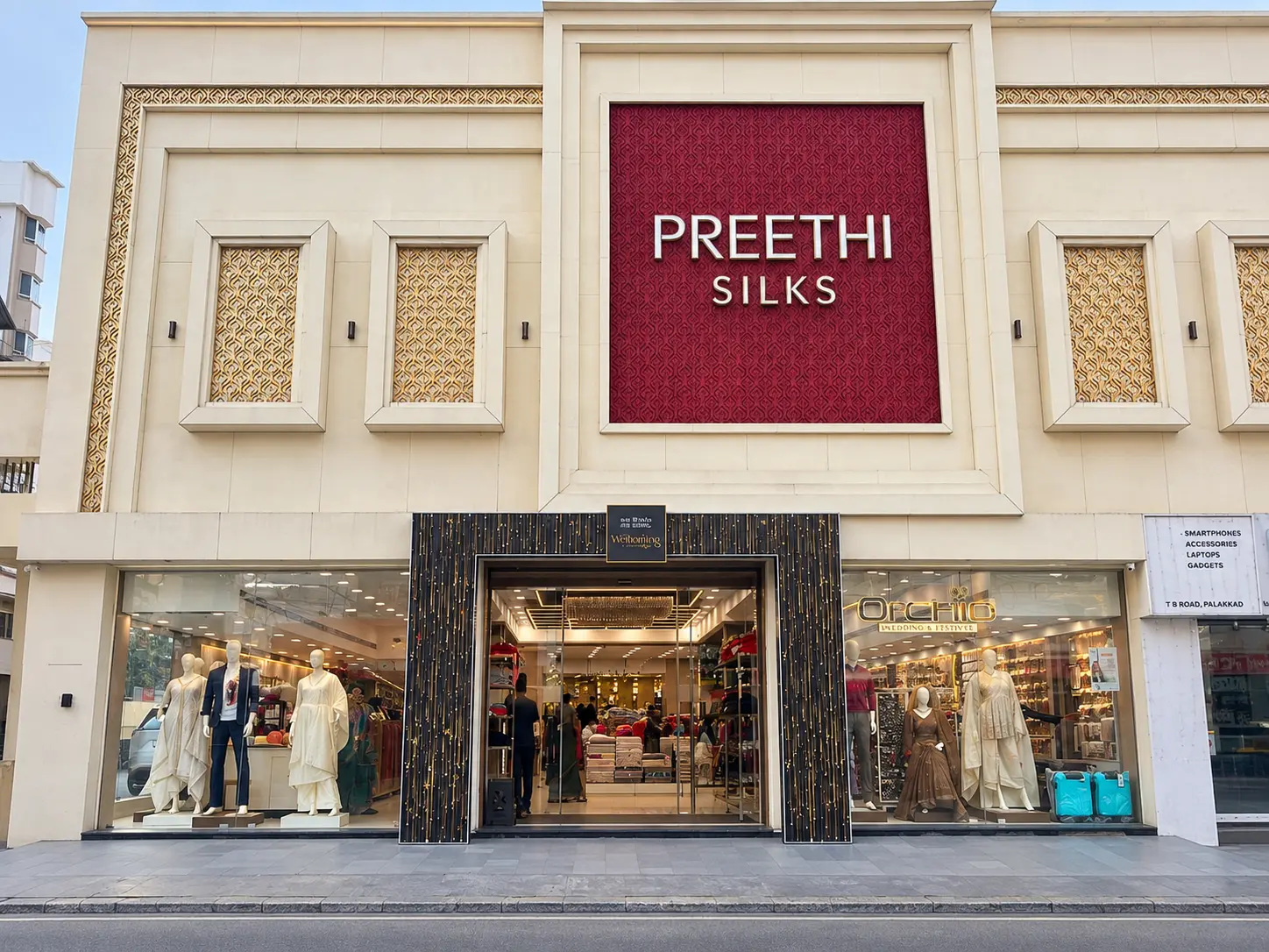 A traditional Indian saree with golden bangles displayed in a premium silk showroom